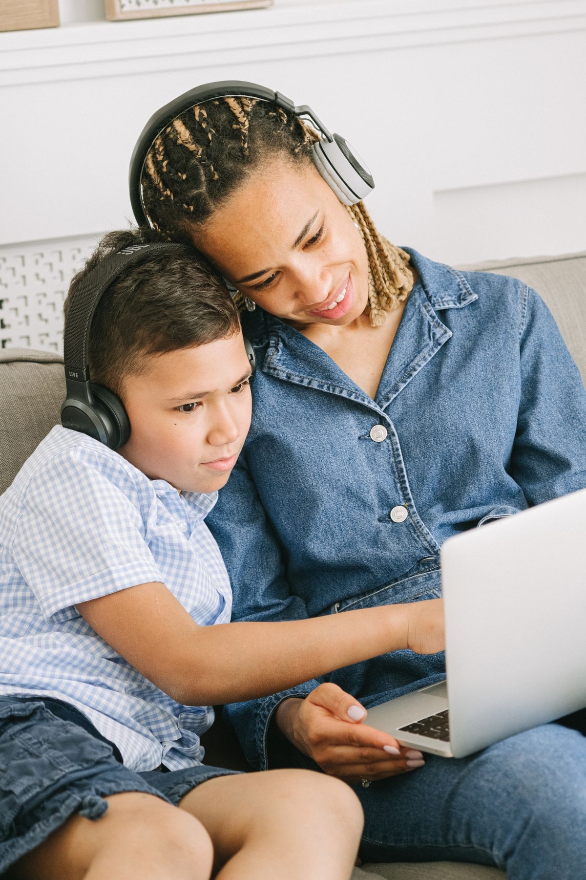 A parent and child looking at a laptop together